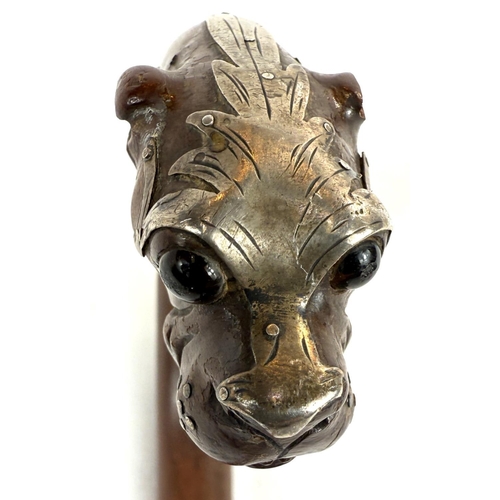 52 - A 19th Century walking stick, the looped handle with finial in the form of a dog's head, silver moun... 