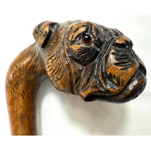 53 - A vintage walking stick with cane shaft and carved wood dog's head handle, 90cm.