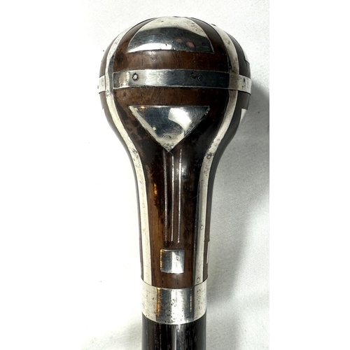 56 - A continental walking stick with hardwood shaft and silver inlaid decoration to the finial in the se... 