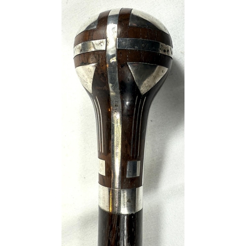 56 - A continental walking stick with hardwood shaft and silver inlaid decoration to the finial in the se... 