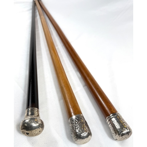 57 - A late 19th Century Malacca walking cane with silver finial, 89cm, and two similar sticks (3).