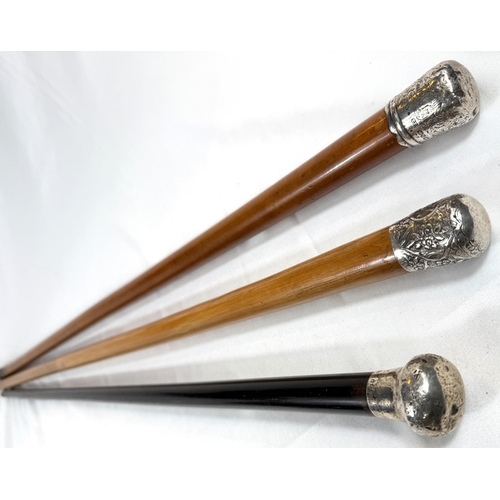 57 - A late 19th Century Malacca walking cane with silver finial, 89cm, and two similar sticks (3).