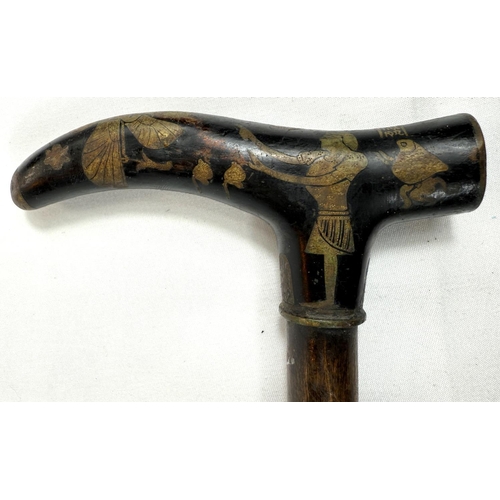 58 - A vintage walking stick with niello work brass handle with Egyptian motifs, 88cm.