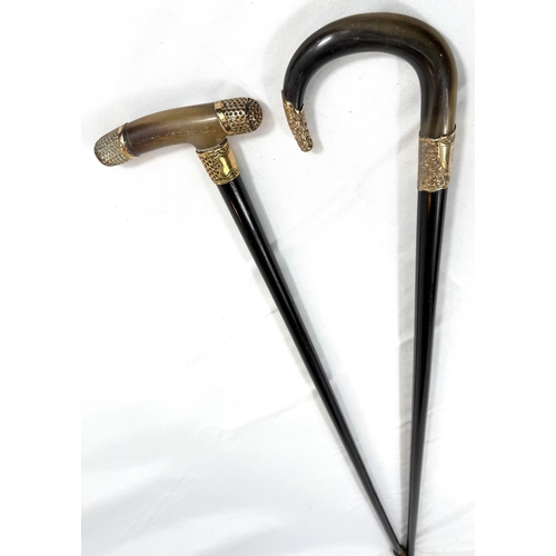 59 - A 19th Century horn-handled stick with gilt metal mounts and ebony shaft, 88cm, and a similar stick ... 