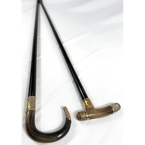 59 - A 19th Century horn-handled stick with gilt metal mounts and ebony shaft, 88cm, and a similar stick ... 