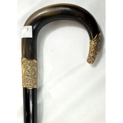 59 - A 19th Century horn-handled stick with gilt metal mounts and ebony shaft, 88cm, and a similar stick ... 