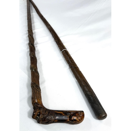 60 - A 19th Century continental vineyard stick with figural decoration, 90cm, and another with carved lio... 