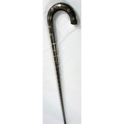 64 - An early 20th Century Indian wooden stick covered in white metal scrolled floral wirework decoration... 