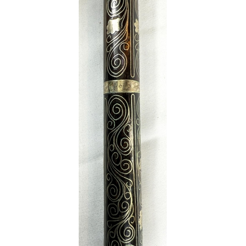 64 - An early 20th Century Indian wooden stick covered in white metal scrolled floral wirework decoration... 