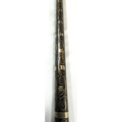 64 - An early 20th Century Indian wooden stick covered in white metal scrolled floral wirework decoration... 