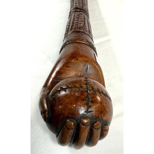 65 - A vintage carved hardwood stick of Asian origin, the finial with hand clasping a cricket ball, 91cm,... 