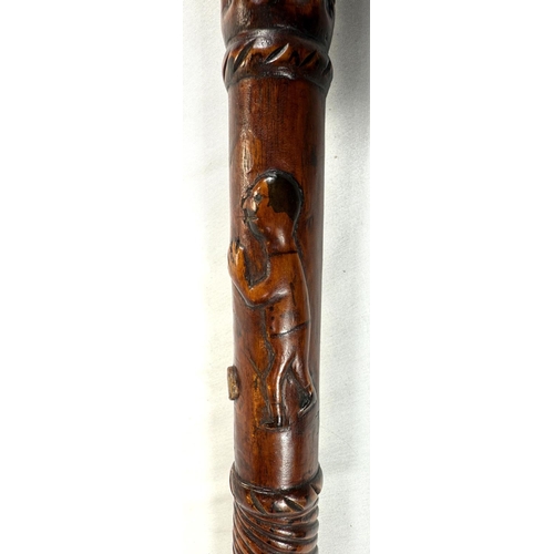 65 - A vintage carved hardwood stick of Asian origin, the finial with hand clasping a cricket ball, 91cm,... 