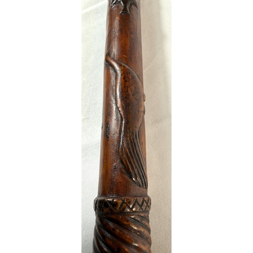 65 - A vintage carved hardwood stick of Asian origin, the finial with hand clasping a cricket ball, 91cm,... 