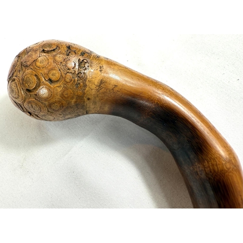 66 - A late 19th/early 20th Century Japanese walking stick with finely carved decoration of three monkeys... 