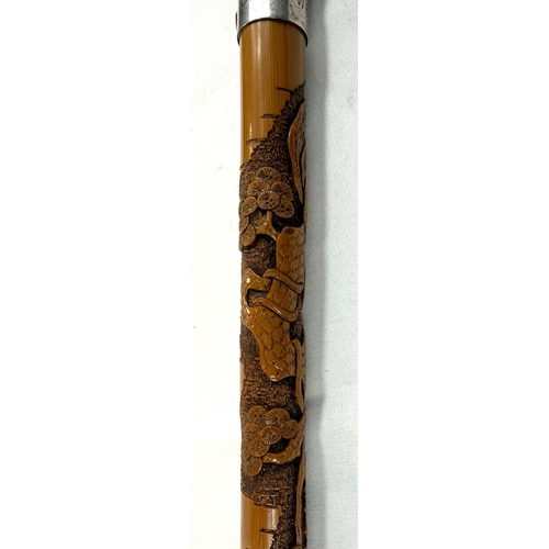 66 - A late 19th/early 20th Century Japanese walking stick with finely carved decoration of three monkeys... 