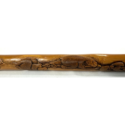 66 - A late 19th/early 20th Century Japanese walking stick with finely carved decoration of three monkeys... 