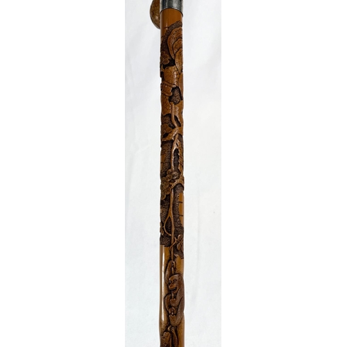 66 - A late 19th/early 20th Century Japanese walking stick with finely carved decoration of three monkeys... 