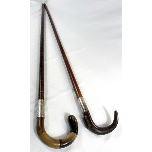 68 - Two vintage silver-mounted horn-handled walking sticks, 92cms each (2).