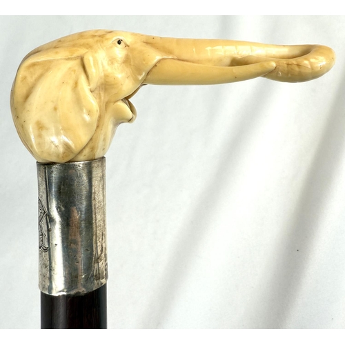 7 - A 19th Century walking stick with carved ivory elephant's head handle and silver band, 92cms, and si... 