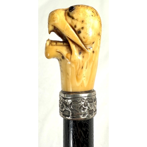 7 - A 19th Century walking stick with carved ivory elephant's head handle and silver band, 92cms, and si... 