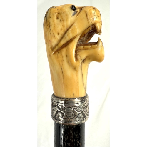 7 - A 19th Century walking stick with carved ivory elephant's head handle and silver band, 92cms, and si... 