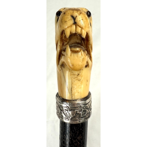 7 - A 19th Century walking stick with carved ivory elephant's head handle and silver band, 92cms, and si... 