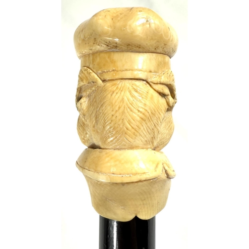 9 - A 19th Century walking stick with carved ivory finial of a bulldog in a driver's cap, 89cms.Submissi... 