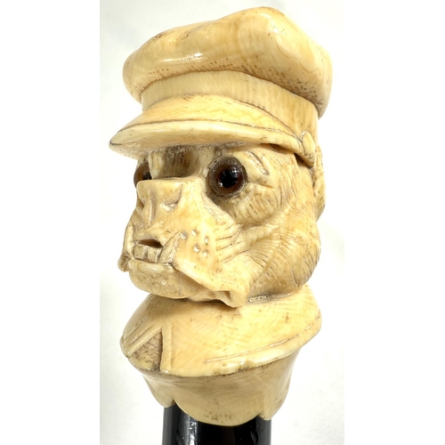 9 - A 19th Century walking stick with carved ivory finial of a bulldog in a driver's cap, 89cms.Submissi... 