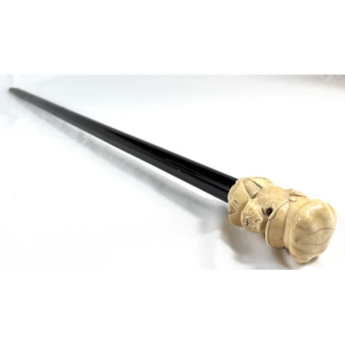 9 - A 19th Century walking stick with carved ivory finial of a bulldog in a driver's cap, 89cms.Submissi... 