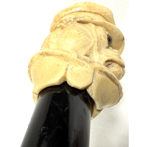 9 - A 19th Century walking stick with carved ivory finial of a bulldog in a driver's cap, 89cms.Submissi... 