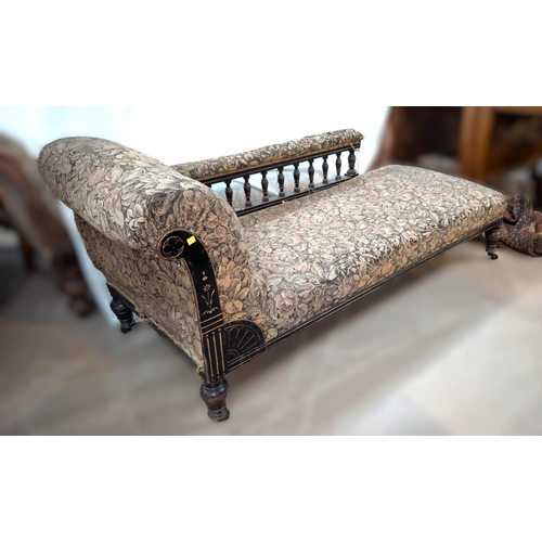 1020 - An ebonised framed spindle back chaise longue in floral tapestry upholstery.