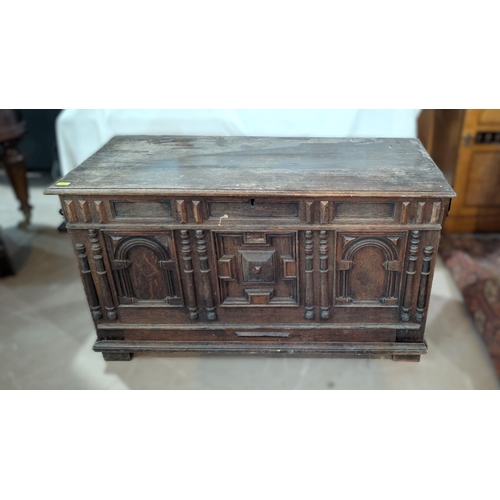 1021 - An 18th century oak framed and panelled blanket box with plank top and 3 arched panels to the front,... 