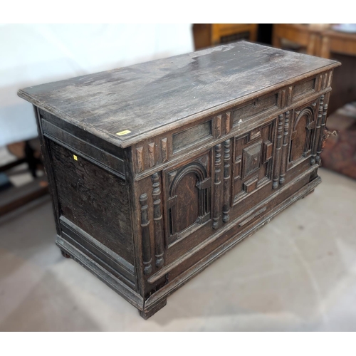 1021 - An 18th century oak framed and panelled blanket box with plank top and 3 arched panels to the front,... 