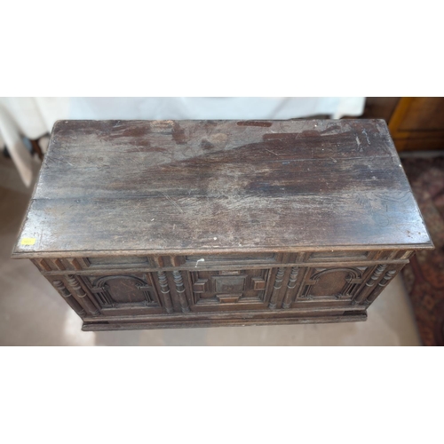 1021 - An 18th century oak framed and panelled blanket box with plank top and 3 arched panels to the front,... 