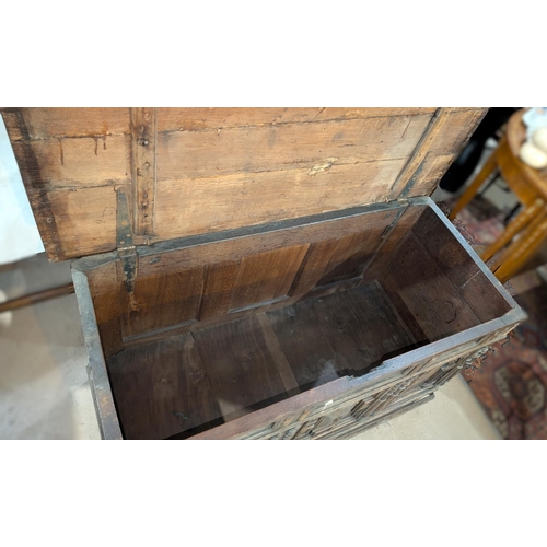 1021 - An 18th century oak framed and panelled blanket box with plank top and 3 arched panels to the front,... 