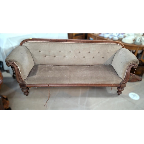 1022 - A Victorian mahogany show frame settee with scrolled ends, turned legs and buttoned fawn dralon (nee... 