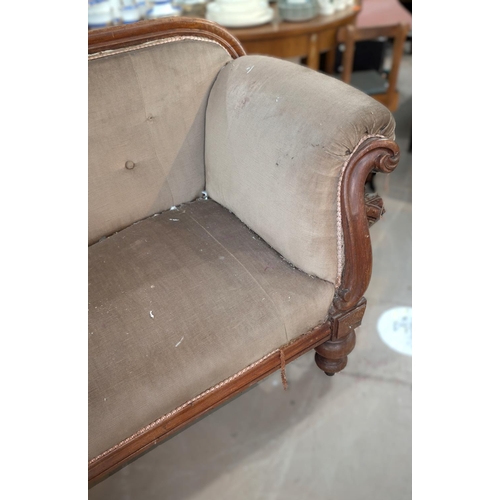 1022 - A Victorian mahogany show frame settee with scrolled ends, turned legs and buttoned fawn dralon (nee... 