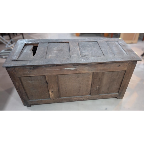 1023 - An 18th century oak framed and panelled blanket box with extensive carved decoration enclosed by 2 d... 