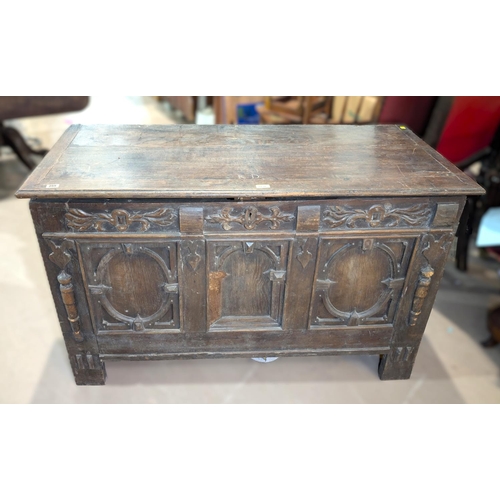 1030 - A late 17th/early 18th century framed and panelled oak blanket box with plank top carved frieze and ... 