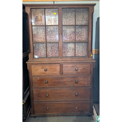 1031 - A Victorian full height pitch pine book case with reeded side pillars comprising upper section with ... 