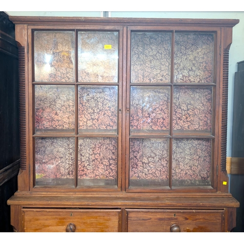 1031 - A Victorian full height pitch pine book case with reeded side pillars comprising upper section with ... 