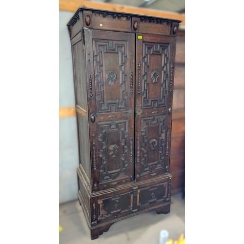 1032 - A 19th century William and Mary style oak side cabinet with extensive geometric moulding enclosed by... 