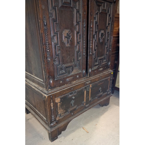 1032 - A 19th century William and Mary style oak side cabinet with extensive geometric moulding enclosed by... 