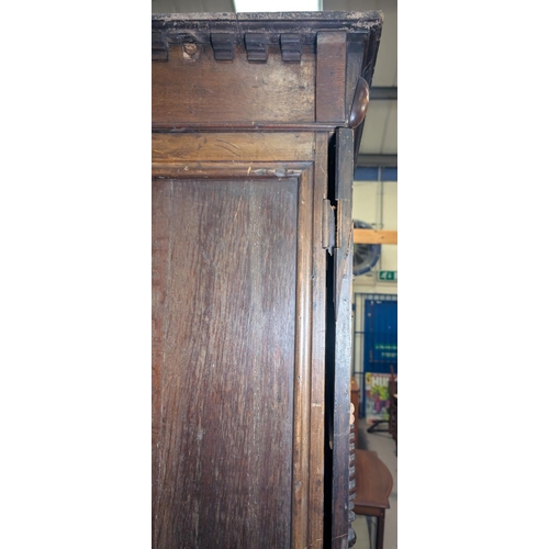 1032 - A 19th century William and Mary style oak side cabinet with extensive geometric moulding enclosed by... 