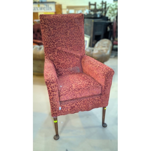 1034 - A 19th century high back armchair on slender club legs in embossed rust fabric.