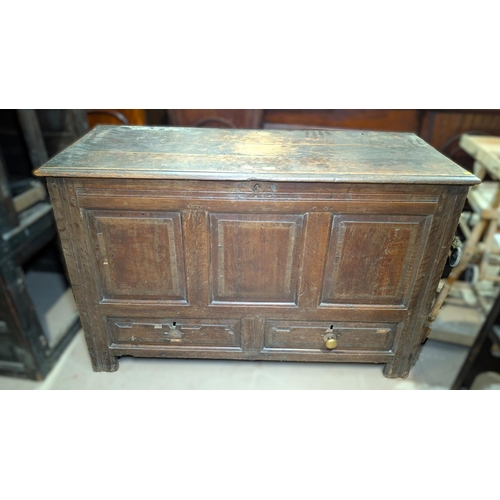 1038 - An 18th century oak mule chest with hinged lid and tripe fielded panels to the front, 2 drawers belo... 