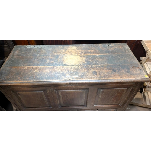 1038 - An 18th century oak mule chest with hinged lid and tripe fielded panels to the front, 2 drawers belo... 