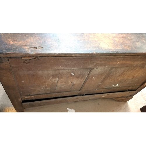 1038 - An 18th century oak mule chest with hinged lid and tripe fielded panels to the front, 2 drawers belo... 