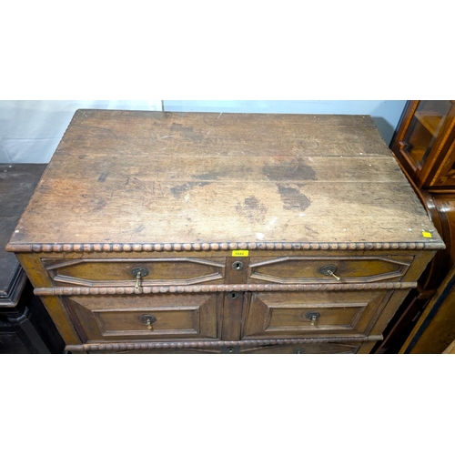 1042 - An 18th century oak chest of drawers with beaded decoration and 4 long drawers with geometric mouldi... 