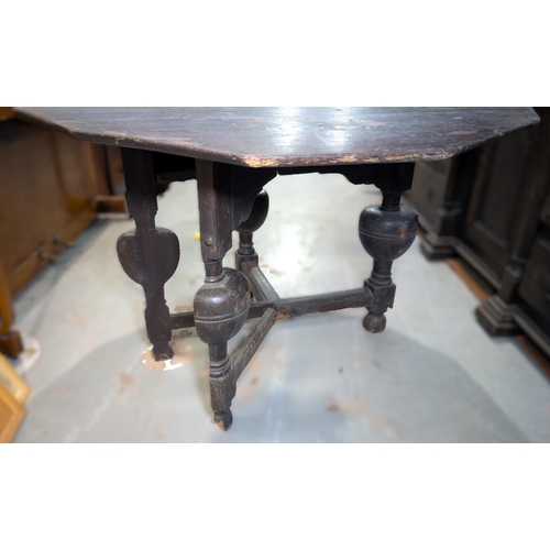 1043 - An 18th century canted oak fold over occasional table on heavy turned bulbous legs and cross stretch... 